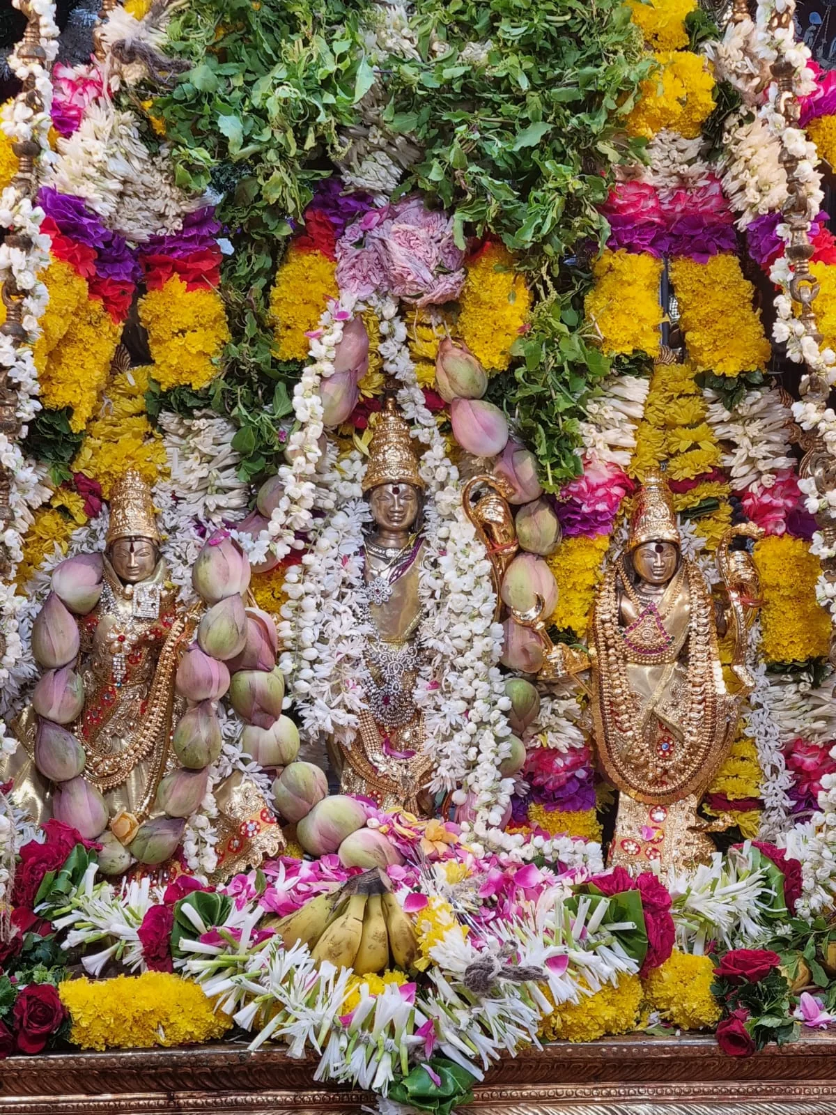Utsava Murti surrounded by flowers during Rama Navami celebrations